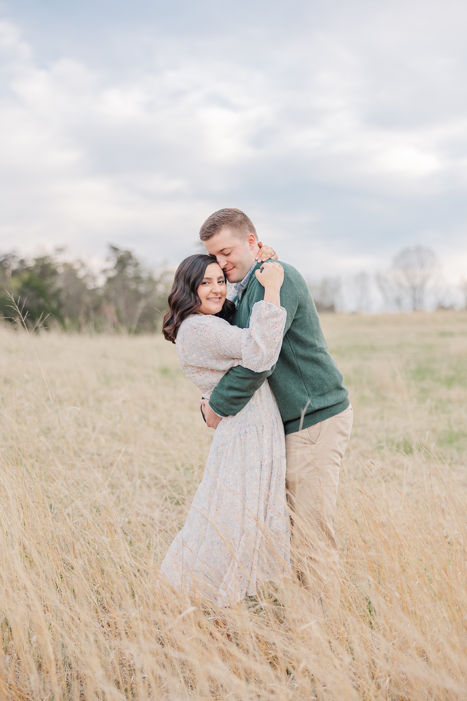 Couple hugging each other in tall grass at Manassa Battlefield in Northern Virginia