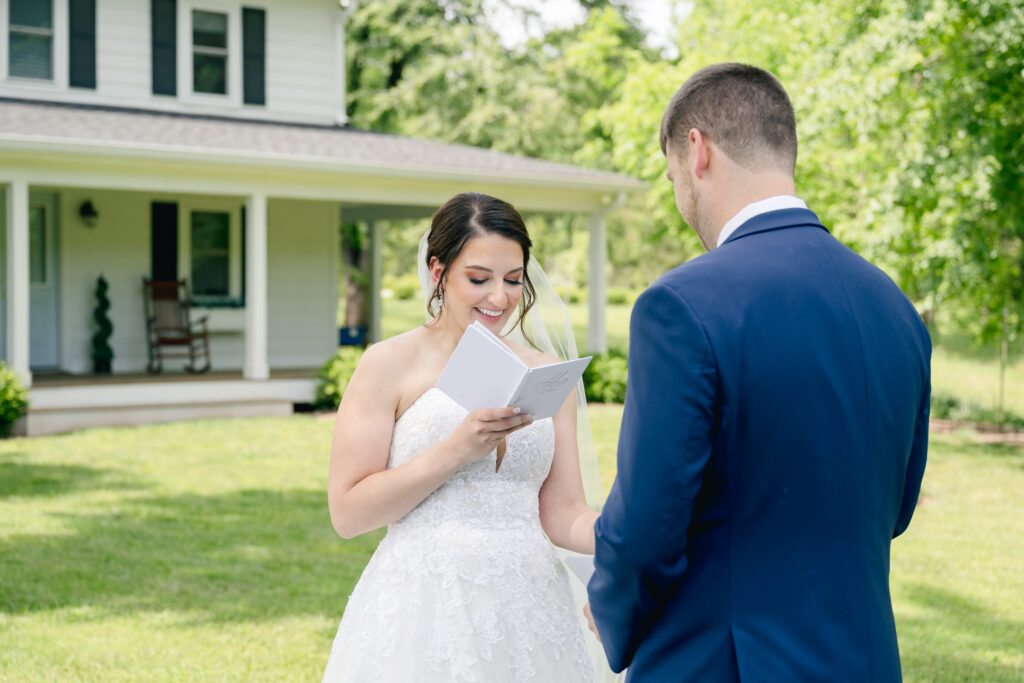 bride reading vows to groom during first look