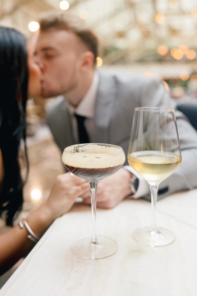 couple kissing during date night at Waldorf Astoria Bar in Washington DC